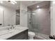 Modern bathroom featuring a glass enclosed shower, stylish vanity, and patterned tile at 2575 Peachtree Ne Rd # 11D, Atlanta, GA 30305