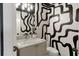 Stylish powder room features bold wallpaper, marble countertop, and contemporary fixtures at 2575 Peachtree Ne Rd # 11D, Atlanta, GA 30305