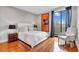 Cozy bedroom with hardwood floors, large windows, and stylish decor at 2575 Peachtree Ne Rd # 11D, Atlanta, GA 30305
