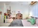 bedroom with a gray comforter and plenty of toys at 40 Sweet Cane Ct, Grayson, GA 30017