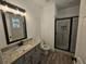 Modern bathroom with granite vanity, large mirror, and walk-in shower at 420 Florence Rd, Douglasville, GA 30134