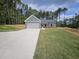 Newly built home with gray siding, two-car garage and landscaped lawn at 420 Florence Rd, Douglasville, GA 30134