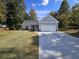Newly built home with gray siding, two-car garage and landscaped lawn at 420 Florence Rd, Douglasville, GA 30134