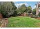 Landscaped backyard with lush lawn and wooden gate at 3051 Oglethorpe Ne Way, Brookhaven, GA 30319