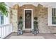 Elegant front door with a wreath, flanked by planters and lanterns at 3051 Oglethorpe Ne Way, Brookhaven, GA 30319