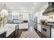Well-designed kitchen with white cabinetry, stainless steel appliances, and a farmhouse sink at 3051 Oglethorpe Ne Way, Brookhaven, GA 30319