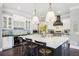 Modern kitchen boasts white cabinets, marble island, and high-end appliances at 3051 Oglethorpe Ne Way, Brookhaven, GA 30319