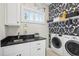Bright laundry room with washer, dryer, and stylish black countertop at 3051 Oglethorpe Ne Way, Brookhaven, GA 30319