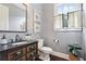 Elegant powder room with dark vanity, gray walls, and decorative mirror at 3051 Oglethorpe Ne Way, Brookhaven, GA 30319