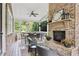 Cozy screened porch with brick fireplace and seating area at 3051 Oglethorpe Ne Way, Brookhaven, GA 30319