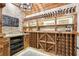 Custom-built wine cellar with rustic wooden shelving and brick accents at 3051 Oglethorpe Ne Way, Brookhaven, GA 30319