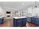 Modern kitchen with two-toned blue and white cabinets, stainless steel appliances and an island at 8630 Amsbury Way, Cumming, GA 30041