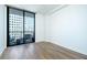 Bedroom with hardwood floors and balcony access at 3040 Peachtree Rd # 802, Atlanta, GA 30305