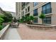Relaxing courtyard with brick pathways, seating areas, and lush landscaping at 3040 Peachtree Rd # 802, Atlanta, GA 30305