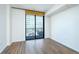 Bright living room with hardwood floors and balcony access at 3040 Peachtree Rd # 802, Atlanta, GA 30305