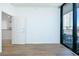 Bright living room with hardwood floors and access to a balcony at 3040 Peachtree Rd # 802, Atlanta, GA 30305