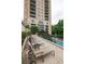Enjoy this resort-style pool deck with lounge chairs and building view at 3040 Peachtree Rd # 802, Atlanta, GA 30305