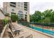 Relaxing pool deck with lounge chairs and building view at 3040 Peachtree Rd # 802, Atlanta, GA 30305
