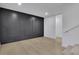 Modern basement features a dramatic dark gray accent wall and light wood flooring at 1770 Austin Dr, Decatur, GA 30032