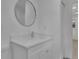 Modern bathroom with white vanity and a large, round mirror at 1770 Austin Dr, Decatur, GA 30032