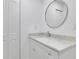 Clean bathroom with white vanity and a large round mirror at 1770 Austin Dr, Decatur, GA 30032