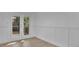 Bright dining room with white wainscoting and french doors leading to a deck at 1770 Austin Dr, Decatur, GA 30032