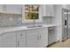 Modern kitchen with white cabinets, quartz countertops and stainless steel appliances at 1770 Austin Dr, Decatur, GA 30032