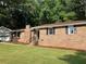 Brick ranch home with a landscaped yard and attached garage at 470 Ovara Ct, Stone Mountain, GA 30088