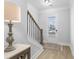 Bright entryway with hardwood floors, a staircase, and a table with a lamp at 2133 Kirkham Way, Kennesaw, GA 30152