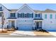Two-story townhome with gray and white siding, two-car garage, and landscaping at 2133 Kirkham Way, Kennesaw, GA 30152