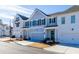 Row of townhomes with gray and white siding, two-car garages, and a paved street at 2133 Kirkham Way, Kennesaw, GA 30152