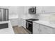 Modern kitchen with white cabinets, stainless steel appliances, and a quartz countertop at 2133 Kirkham Way, Kennesaw, GA 30152