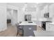 Open concept kitchen with white cabinets, gray island, stainless steel appliances, and hardwood floors at 2133 Kirkham Way, Kennesaw, GA 30152