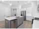 Modern kitchen with white cabinets, gray island, and stainless steel appliances at 2133 Kirkham Way, Kennesaw, GA 30152