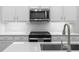 Modern kitchen with white cabinets, stainless steel appliances and quartz countertops at 2133 Kirkham Way, Kennesaw, GA 30152
