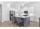 Modern kitchen with white cabinets, a gray island, stainless steel appliances, and hardwood floors at 2133 Kirkham Way, Kennesaw, GA 30152