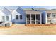 View of the backyard of a new construction home, featuring a screened porch and grassy area at 2133 Kirkham Way, Kennesaw, GA 30152