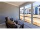 Inviting screened porch with wicker chairs, perfect for outdoor relaxation and overlooking the backyard at 2133 Kirkham Way, Kennesaw, GA 30152
