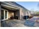 Back porch with outdoor seating on brick-laid patio and a view of the back yard at 331 Wages Rd, Auburn, GA 30011