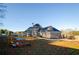Large, well maintained backyard with play equipment, an expansive lawn and beautiful home exterior at 331 Wages Rd, Auburn, GA 30011