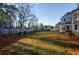 Large fenced backyard ideal for Gathering gatherings, featuring a mix of lawn and natural surroundings at 331 Wages Rd, Auburn, GA 30011