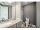 Bathroom featuring a granite countertop sink, tiled floors, and a shower with gray-striped curtain at 331 Wages Rd, Auburn, GA 30011