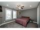 Inviting bedroom with a ceiling fan, two large windows, and neutral paint at 331 Wages Rd, Auburn, GA 30011