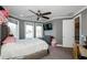 Cozy bedroom with large windows, ceiling fan, neutral gray paint, and plush carpet, creating a relaxing space at 331 Wages Rd, Auburn, GA 30011