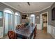 Formal dining room with decorative lighting, arched windows, and seating for ten at 331 Wages Rd, Auburn, GA 30011