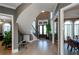 Elegant foyer with curved staircase, hardwood floors, and abundant natural light at 331 Wages Rd, Auburn, GA 30011
