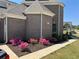 Brick home with lush landscaping featuring vibrant pink flowers and manicured lawn at 331 Wages Rd, Auburn, GA 30011