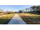 An exterior view highlighting the extensive driveway and surrounding landscape leading up to the home at 331 Wages Rd, Auburn, GA 30011