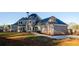 Elegant exterior showcases solar panels, a brick facade, well-kept lawn, and outdoor seating at 331 Wages Rd, Auburn, GA 30011