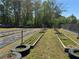 Large garden area featuring raised beds, black ground cover, and surrounding greenery at 331 Wages Rd, Auburn, GA 30011